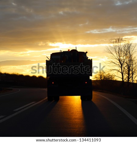 Truck traveling at sunset.