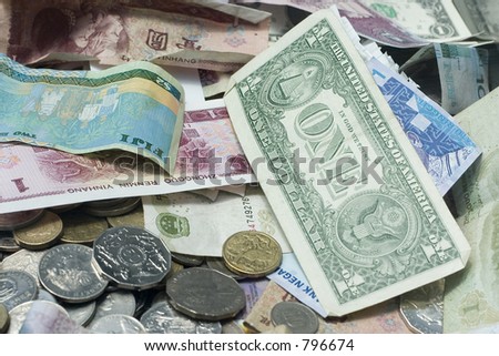 Stack of different notes from around the world with the US cash being prominent as the number one currency.