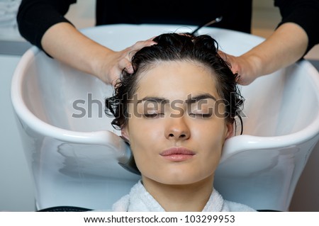 Beautiful woman getting a hair wash. In a hair salon