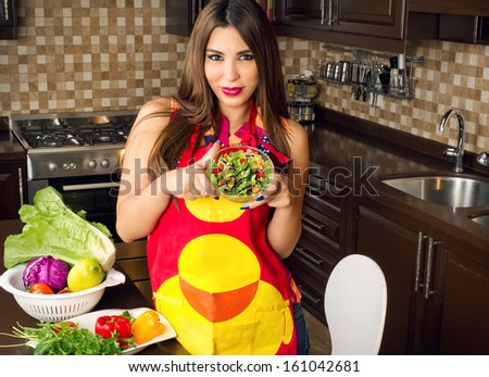 Beautiful woman serving home made salad