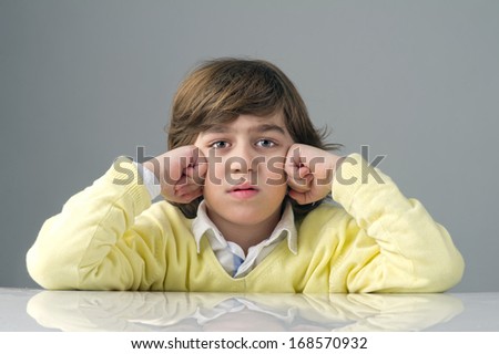 beautiful kid with deep thoughts thinking isolated against grey background