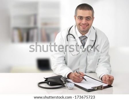 Arab doctor in his office writing notes in his office Arab doctor in his office writing notes in his office