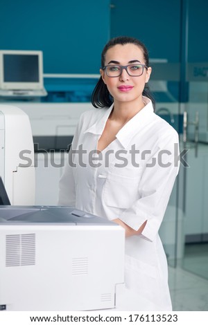 Beautiful scientist working on the computer in a modern lab
