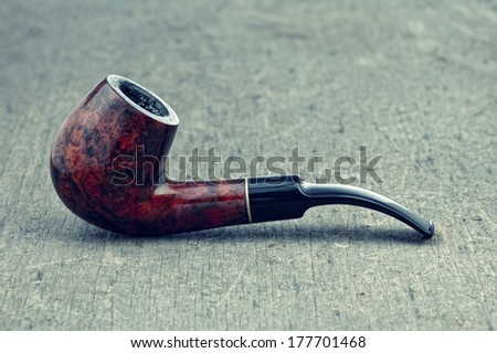 Vintage Pipe shot on a wooden background with retro filter effect