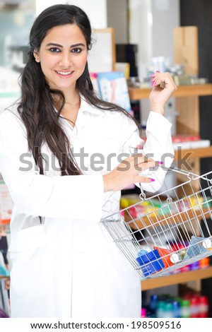 Woman holding a basket of cosmetics in a pharmacy