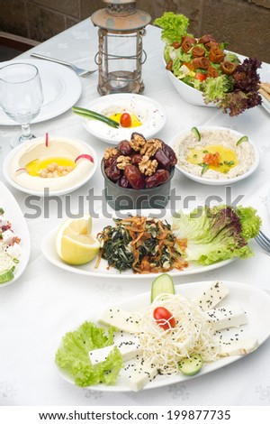Arabic food of dates, hommos, cheese, labneh and fattoush served in Ramadan