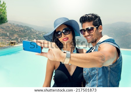 Portrait of group of friends taking photos with a smartphone, Couples taking Selfie
