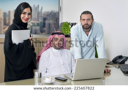 Multiracial Business Meeting in office , arabian businessman & arabian Secretary wearing hijab & a Foreigner meeting in office