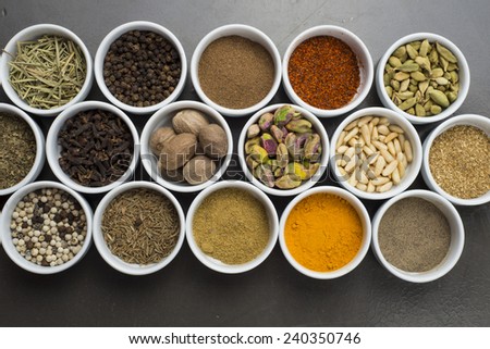 large collection of different spices and herbs isolated on dark background