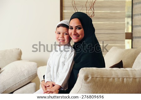 Arabic family, mother and son sitting on the couch in their living room