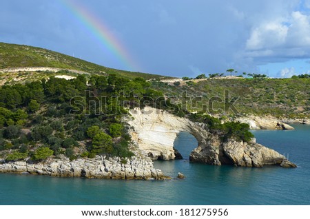 Rainbow over the rock window near Vieste, Gargano, Italy