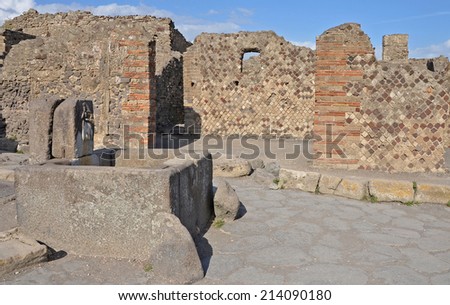 Ancient stone fountain at the end of the street, Pompeii, Italy. Built as a source of drinking water.