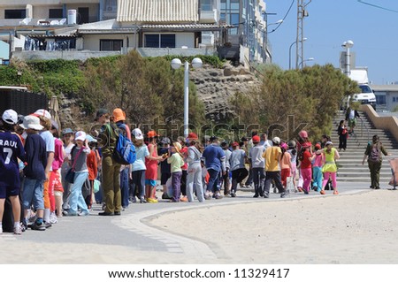 Beach Tel-Aviv in Israel. Children and armed security forces.