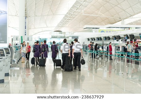 Hong Kong, China - November 01: Pilots and air walking in the lobby of Hong Kong airport on November, 01, 2014 in Hong Kong, China. Hong Kong airport handles many air line per year.