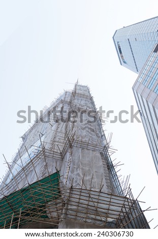 building facade covered for restoration work under the sky in Hong Kong, China. heavy processed for new desing