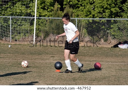 Female soccer player dribbles