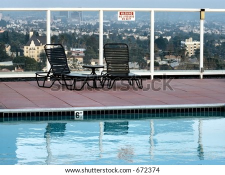 Roof top swimming pool with a pair chaise lounges