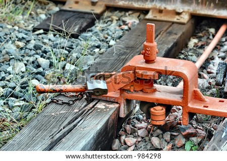 Rail switch mechanism locked into place with a chain an padlock