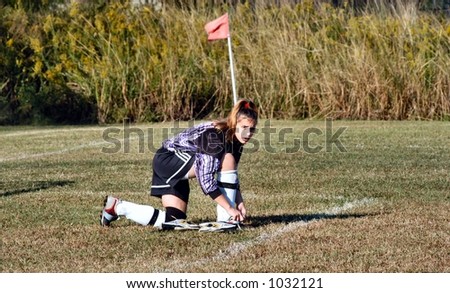 Female soccer goal keeper changing her cleats