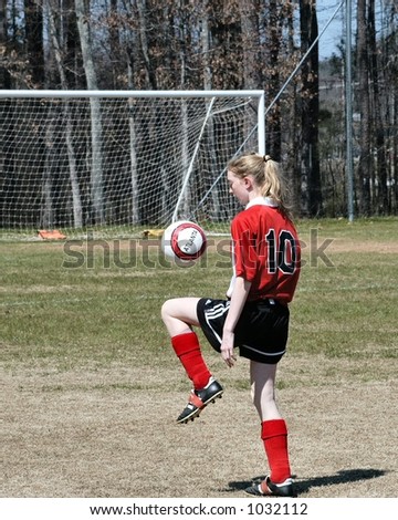 Female soccer player juggling the ball