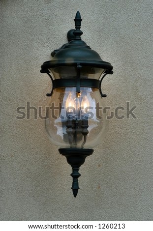 Front view of a Lighted light fixture hanging on a wall.