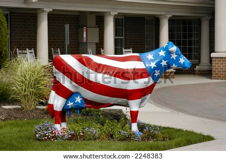Side view of a cow statue painted like an american flag