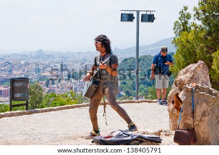 BARCELONA-JULY 25: Vagrant musician sing a song on July 25, 2012 in Barcelona. Barcelona is the capital of Catalonia and the second largest city in Spain with a population of 1,621,537.