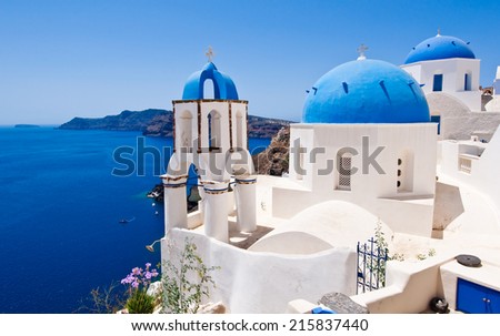 Oia Orthodox churches and the bell-tower. Santorini island, Greece.