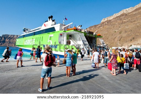 SANTORINI-JULY 28: Tourists board on the ferry on July 28, 2014 on the port of Thira. Santorini, Greece.