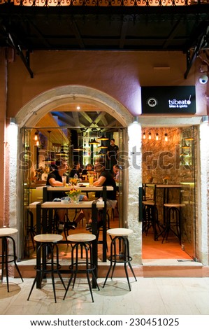CORFU-AUGUST 25: Young people have drinks in a local restaurant on August 25, 2014 on Corfu island, Greece. Kerkyra is a town on the island of Corfu in the Ionian Sea, Greece.