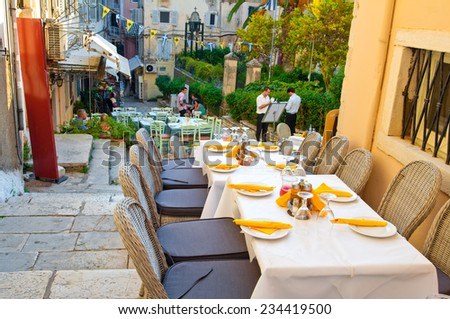CORFU-AUGUST 27: Cosy outside restaurant invites its guests to have dinner with warm atmosphere on August 27,2014 on the island of Corfu, Greece.