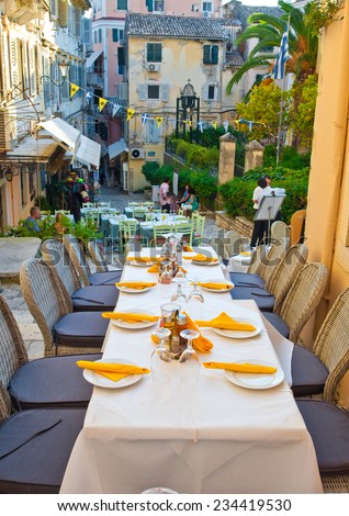 CORFU-AUGUST 27: Cosy outside restaurant invites its guests to have a meal on August 27,2014 on the island of Corfu, Greece.