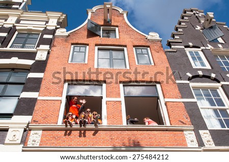 AMSTERDAM,NETHERLANDS APRIL 27: Local youth celebrate King\'s Day in city center on April 27, 2015 in Amsterdam. King\'s Day is the biggest street party of the year.