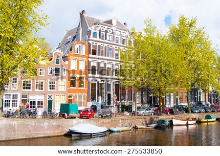 AMSTERDAM,NETHERLANDS-APRIL 27: Amsterdam canal with cars and boats along the bank on April 27, 2015 in Amsterdam, the Netherlands.