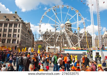 AMSTERDAM-APRIL 27: Crowd of people in orange on Dam Square during King\'s Day on April 27, 2015 in Amsterdam, Netherlands. King\'s Day is a national holiday celebrated on April 27th.