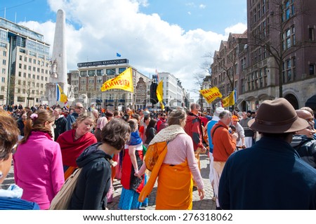 AMSTERDAM,NETHERLANDS-APRIL 27: People in traditional orange on Dam Square during King\'s Day on April 27,2015 in Amsterdam.  King\'s Day is the largest open-air festivity in Amsterdam.