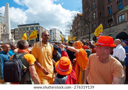 AMSTERDAM,NETHERLANDS-APRIL 27: Locals and tourists in orange celebrate joyously King\'s Day on April 27,2015 in Amsterdam.  King\'s Day is the largest open-air festivity in Amsterdam.