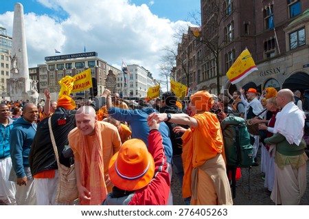 AMSTERDAM,NETHERLANDS-APRIL 27: Locals and tourists in orange celebrate King\'s Day on Dam Square on April 27,2015 in Amsterdam.  King\'s Day is the largest open-air festivity in Amsterdam.