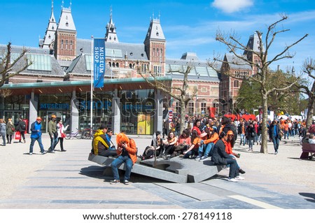 AMSTERDAM-APRIL 27: Crowd of people at the Museumplein during King\'s Day on April 27,2015. Museumplein is a public space between three museums: Rijksmuseum, Van Gogh Museum, and Stedelijk Museum.