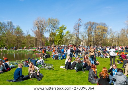 AMSTERDAM-APRIL 27: People in Vondelpark during King\'s Day on April 27,2015, the Netherlands.King\'s Day is the largest open-air festivity in Amsterdam, the Netherlands.
