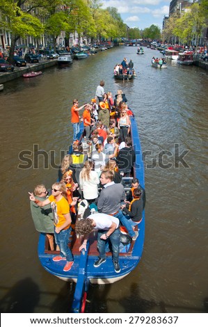 AMSTERDAM-APRIL 27: Local people on Party Boat with unlimited beer celebrate King\'s Day on April 27,2015. King\'s Day is the largest open-air festivity in Amsterdam.