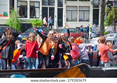 AMSTERDAM-APRIL 27:  King\'s Day boating, youth have fun on the boats on April 27, 2015 in Amsterdam, the Netherlands. King\'s Day (Koningsdag) is held on 27 April every year.