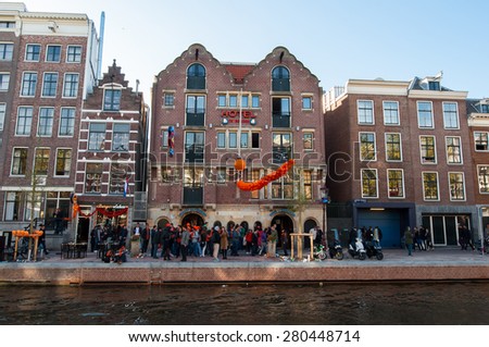 AMSTERDAM-APRIL 27: One of the most visited Bulldog coffeeshop and hotel in red-light district, people celebrate King\'s Day outside the cafe on April 27,2015, the Netherlands.