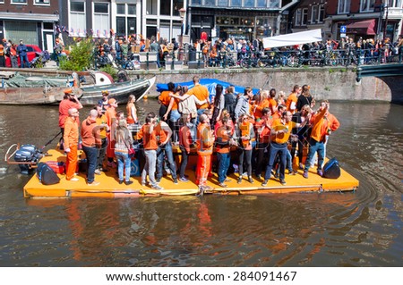 AMSTERDAM-APRIL 27: People in orange celebrate King\'s Day along the Singel canal on the raft on April 27,2015. King\'s Day is the biggest festival celebrating the birth of Dutch royalty.