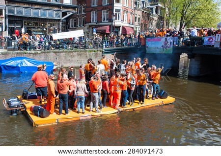 AMSTERDAM-APRIL 27: People celebrate King\'s Day along the Singel canal on the raft on April 27,2015, the Netherlands. King\'s Day is the biggest festival celebrating the birth of Dutch royalty.