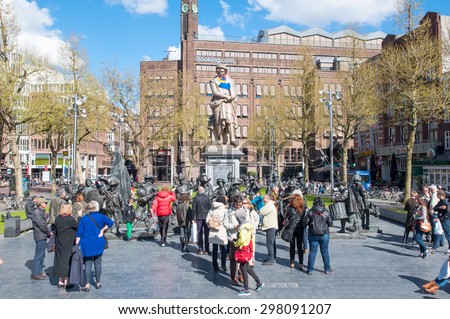Amsterdam-April 30: Rembrandtplein with sculptures of the Night Watch by Russian artists Mikhail Dronov and Alexander Taratynov, tourists go sightseeing on April 30, 2015, the Netherlands.