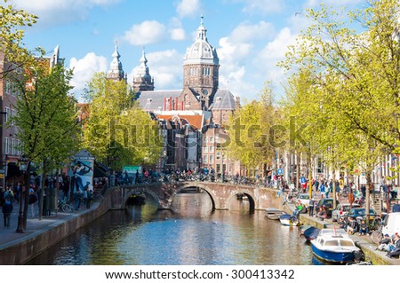 Amsterdam-April 30: Red light district, crowd of tourists go sightseeing, the Church of St. Nicholas is visible in the distance on April 30,2015, the Netherlands.