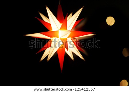 The low key photograph of an illuminated Christmas star/Christmas star