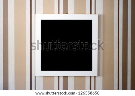 The close-up of a picture frame before a strikingly touched wallpaper/Picture frame