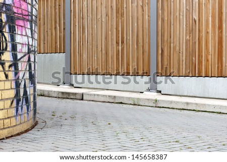 The photograph of a noise protection wall along a walkway/Noise protection wall